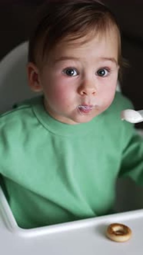 Cute Infant Being Fed With a Spoon