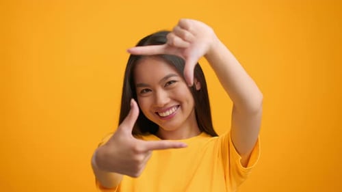 Smiling Woman Framing Face with Hands