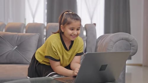 Girl Typing on Laptop at Home