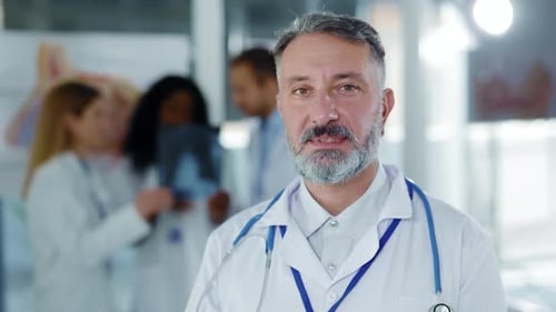 Confident Doctor with Medical Team in Background
