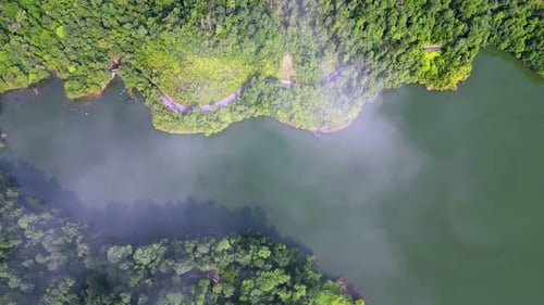 Aerial view white cloud move over the dam and forest