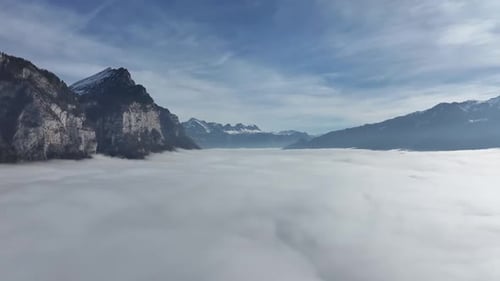 Cliffside above Sea of Fog by Walensee, Switzerland - aerial