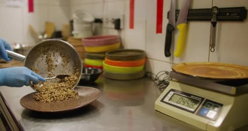 Chef Prepares Buckwheat Dish in a Restaurant Kitchen