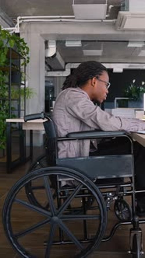 African American Student in a Wheelchair Uses a Laptop to Prepare for an Exam