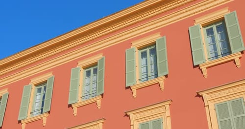 Windows With Wooden Shutter On A Traditional Architecture Facade Exterior In Nice, France. Low Angle