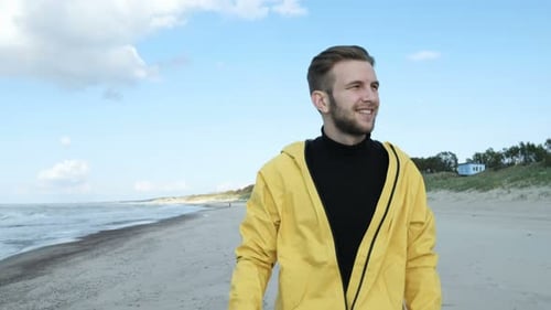 The Picture of Enjoyment Smiling Funny Adult Hipster in Color Coat Walk