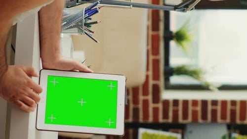 Vertical Video Office Worker Working with Isolated Greenscreen Display on Wireless Device