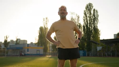 Man with Gray Hair Doing Stretching Exercises
