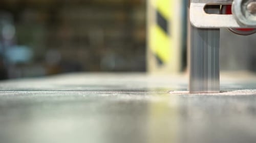 Band Saw Cutting Wood in Light Workshop
