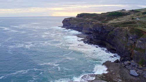 Drone captures cinematic footage of Isla island and the blue Cantabrian sea at sunset