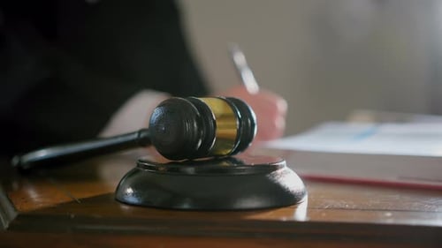 Close Up Shot of Judge's Hand with Wooden Judge Gavel