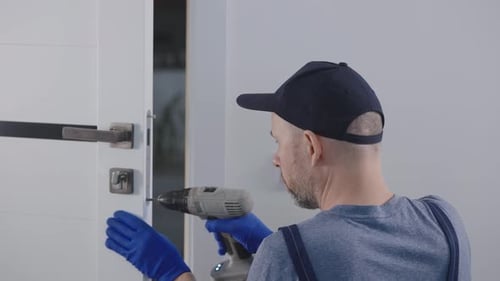 Man Installing Door Handle with Power Drill