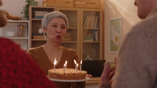 Mature Adults Celebrating Birthday with Cake and Candles