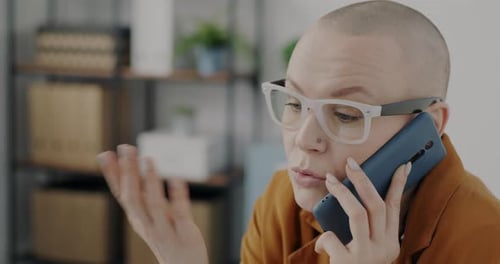 Closeup of Businesswoman Chatting on Mobile Phone and Smiling Working in Office