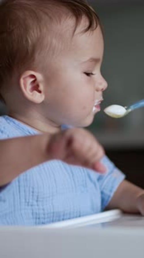 Adorable Infant Being Fed in a Home Setting