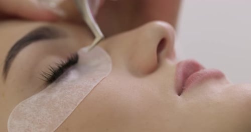 Eyelash Extensions Being Applied on a Young Woman