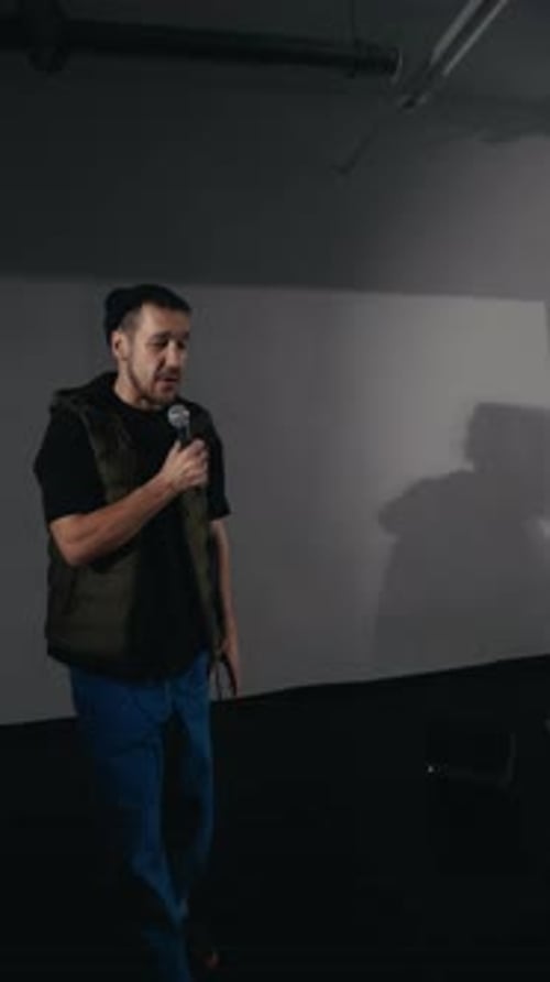 Musical Performance Man Delivers Energetic Performance Singing Into Microphone and Gesturing with