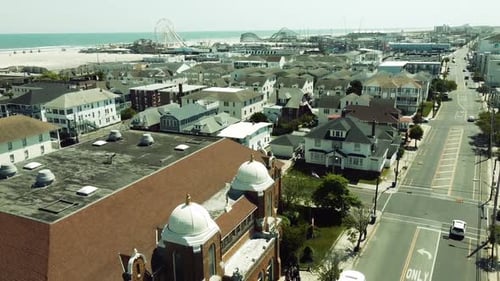 Aerial tilt up of Stone Harbor, New Jersey. View of a small amusement park on the beach.