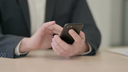 Close up of Businessman Browsing Internet on Smartphone