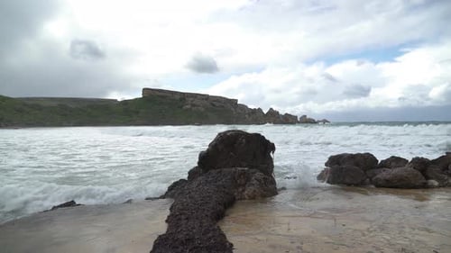 Algae Grows on Stone near Ghajn Tuffieha Bay Shore with Sea Waves Crashing and Splashing