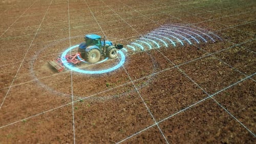 Farm machinery of the future, an autonomous self driving tactor cultivates the soil.