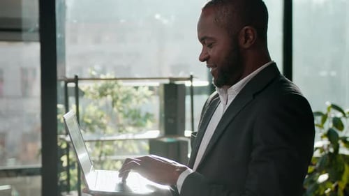 Smiling Ethnic Man African American Businessman Business Agent with Laptop in Corporate Office Adult