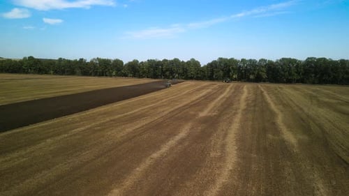 Tractors plowing the field in Ukraine