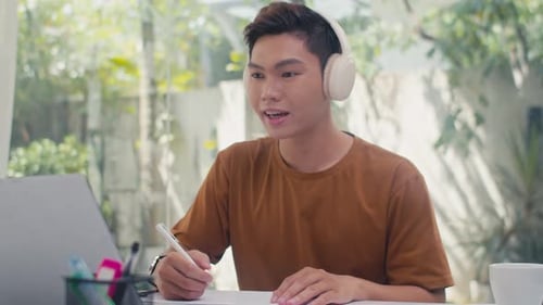 Young Adult Working at Home on Laptop