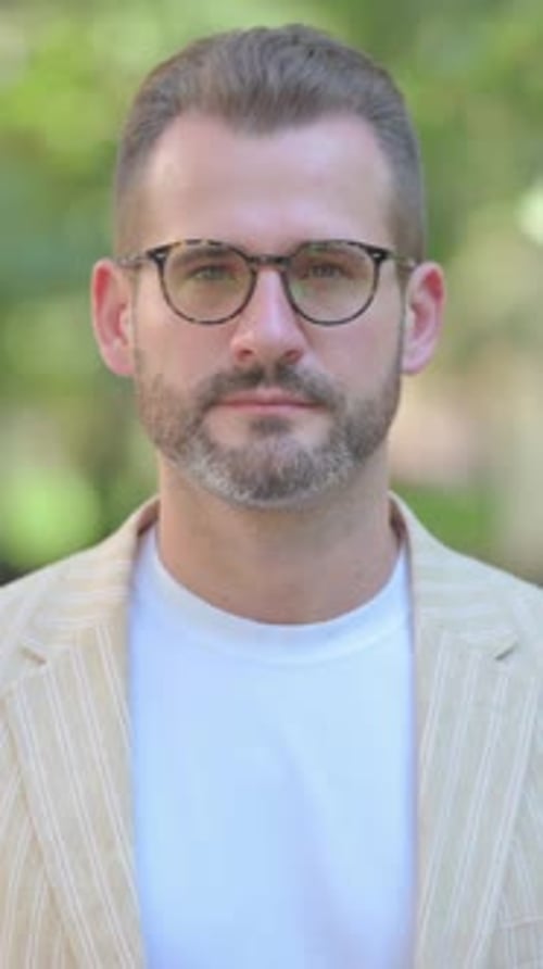 Portrait of a Man with Beard and Glasses Outdoors