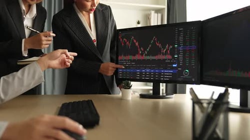 Business Team Analyzes Stock Market Data in Office