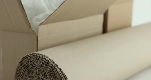 Different packaging materials on white background, closeup. Camera moving up and right