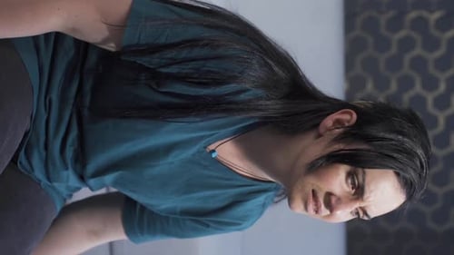 Woman Massaging Sore Leg Muscles on Couch