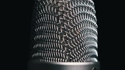 Studio Microphone Rotates on a Black Background CloseUp