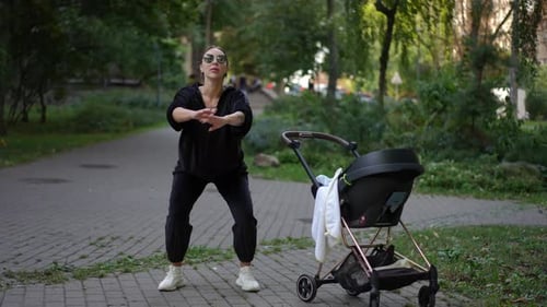Ein engagierter aktiver Elternteil, der mit seinem Kinderwagen in der wunderschönen Parkumgebung trainiert
