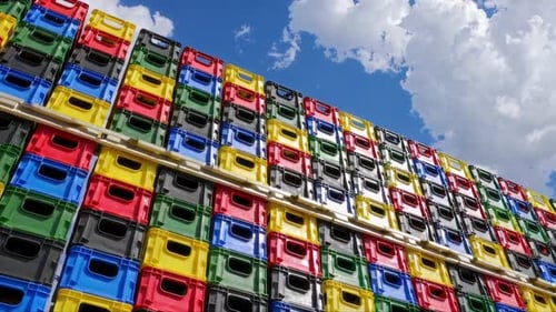 A Collection of Colorful Stacked Plastic Crates is Beautifully Contrasted Against a Bright Sky