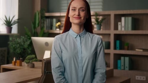 Confident Woman Smiling in Modern Office Environment