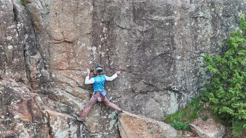 Male Climber Makes His Way Up a Steep Rock Face
