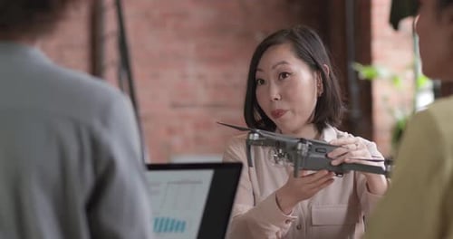 Team Discussing Drone Technology in Office Environment
