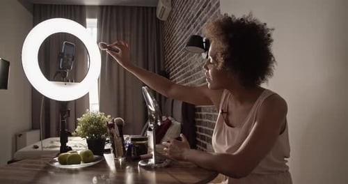 Black Woman Applying Makeup During Live Stream
