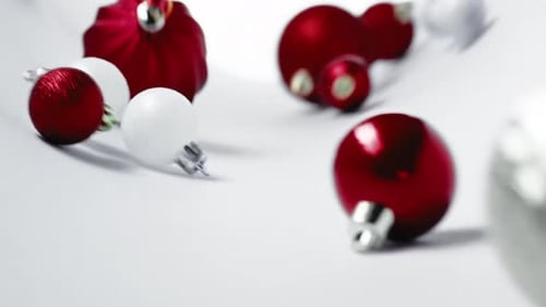 Rolling Christmas Ornaments on White Background