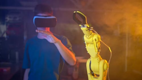 Young Adult Controlling Robot With Virtual Reality Headset