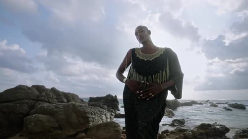 Glamorous Woman Posing on Rocky Ocean Coast