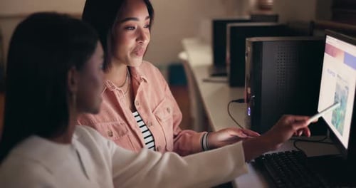 Two Young Women Collaborating on Computer Project