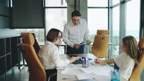 Team Collaboration in a Modern Office Discussing Project Strategies During a Business Meeting with