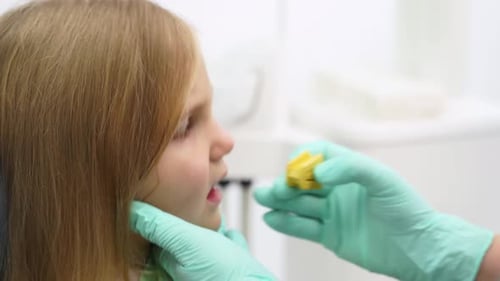 Dentist's Hands Preparing Girl for Teeth Examination in Modern Dental Office Professional