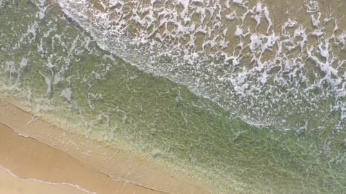 Aerial View of the Sandy Beach with Ocean Waves in Summer
