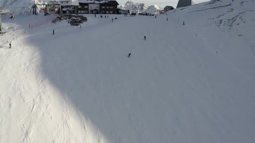 Aerial view of People Skiing and snowboarding on hill, Ski Resort.