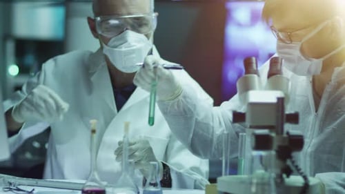 Scientists Working with Microscope and Test Tube