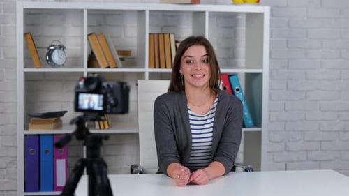 Young Woman Recording a Video Blog at Desk