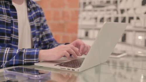 Side View of Man Working on Laptop